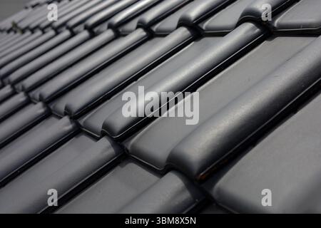 Dark grey ceramic roof tiles background. Vertical perspective Stock Photo