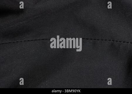 Old worn-out polyester and elastane fabric, pilling and frayed threads. Stock Photo