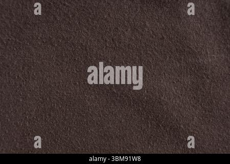 Old battered cotton brown fabric, pilling on the surface Stock Photo