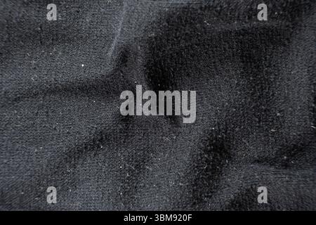 Old worn-out fabric with damaged structure, protruding threads Stock Photo