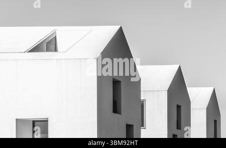 Contemporary minimalist houses on Rua Praia do Bom Sucesso, Lisbon, featuring geometric white facades and angular modernist architecture Stock Photo