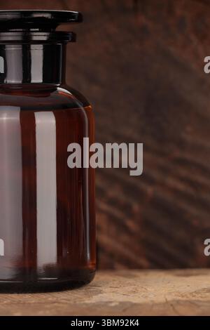 Vintage amber glass bottle on wood Stock Photo