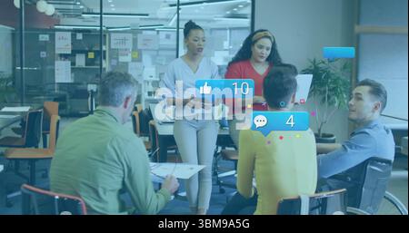 Discussing team in casual attire collaborating around table in office, with tablet and laptop. Collaboration, teamwork, office, modern, business, brai Stock Photo