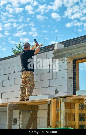 construction worker is working on scaffolding in a private house under construction Stock Photo