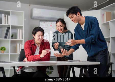 Teamwork and Creative Process. Engaging in UXUI design discussions at a collaborative workspace. Stock Photo