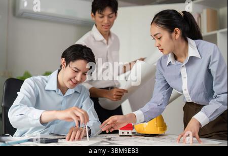 Team Collaboration and Architectural Innovation. Professionals discussing designs and strategies for a construction project. Stock Photo