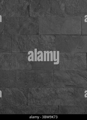 Seamless texture of a dark gray stone wall, creating a rugged and natural backdrop Stock Photo