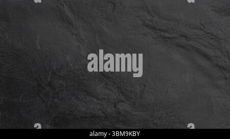 Close-up view of dark gray slate, highlighting its rough and textured surface Stock Photo