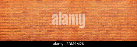 Wide panoramic background image of an orange brick wall forming a seamless texture Stock Photo