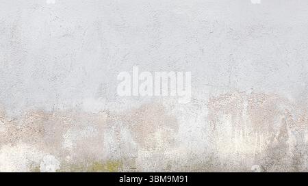 Gray concrete wall with weathered and stained surface, ideal for backgrounds and textures Stock Photo