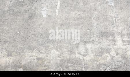 Close-up view of a gray concrete wall revealing a textured surface marked by age, wear, and various imperfections, suitable for backgrounds and design Stock Photo