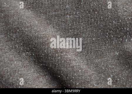 Macro texture of gray fabric with lots of pilling and damage on the surface Stock Photo