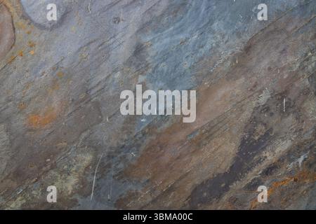 Textured Layered Stone Background with Rust Colors. Abstract Rock Surface Stock Photo