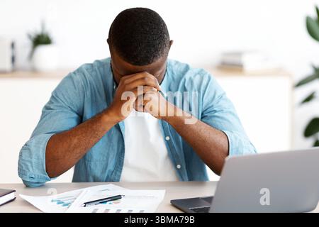 Depressed African American Entrepreneur Having Problems At Work Stock Photo