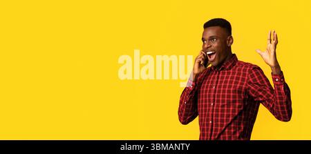 Mobile Communication. Excited African American Guy Emotionally Talking On Cellphone Stock Photo