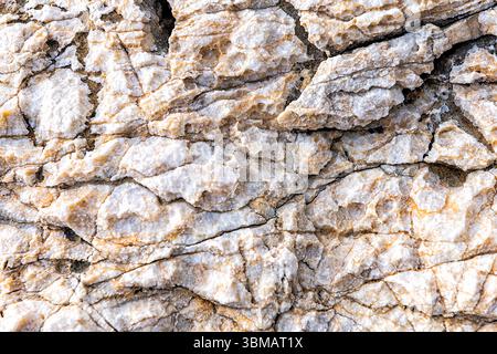 Abstract macro closeup of rock stone white pattern with salt texture by sea in Dionysus cave by Iero beach on Ikaria island, Greece Stock Photo