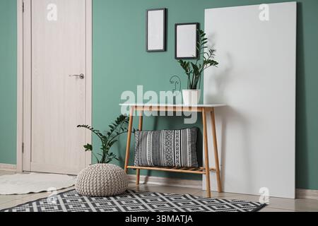 Bench, pouf, folding screen and houseplants in interior of modern hall Stock Photo