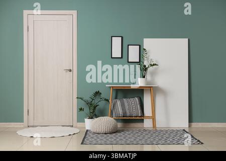 Bench, pouf, folding screen and houseplants in interior of modern hall Stock Photo