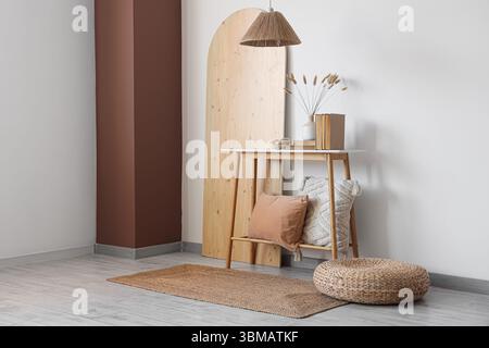Wooden bench, pouf and folding screen in interior of room Stock Photo
