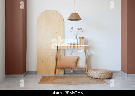 Wooden bench, pouf and folding screen in interior of room Stock Photo
