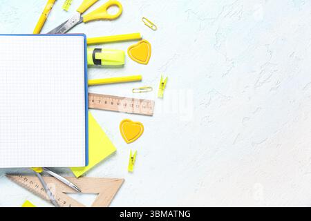 Composition with open notebook and stationery supplies on blue grunge background, closeup Stock Photo