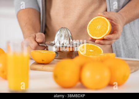 closeup on man making orange juice Stock Photo