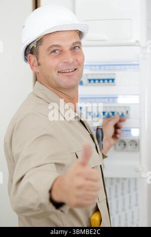 electrician installing energy saving meter Stock Photo