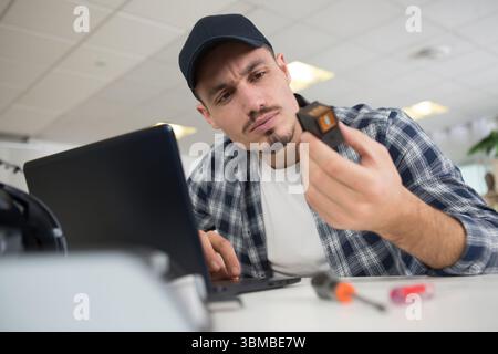 male employee checking the printer and ink Stock Photo