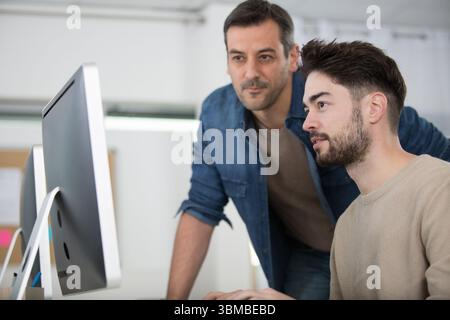 two entrepreneurs working and taking notes together in the office Stock Photo