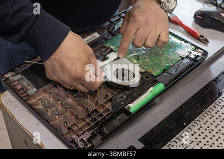 Technician repairing laptop computer closeup Stock Photo