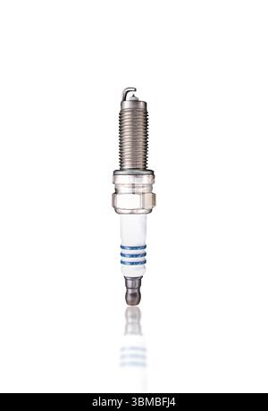 Iridium Spark Plug, A single, new iridium spark plug with a white ceramic insulator and metal threading, isolated on white background include clipping Stock Photo