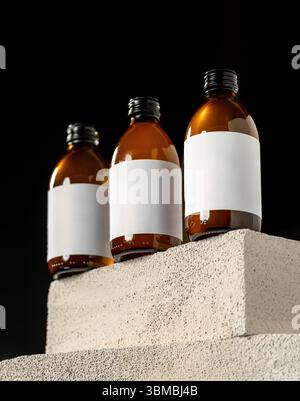 Minimal product photo of amber bottles with blank white labels Stock Photo