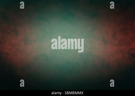 Abstract flat textured background is glowing with teal-green center fading into deep red shadows Stock Photo