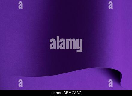 Designer paper in bright and dark violet purple tones with wavy folds and curved shapes. Matte textured surface in elegant monochrome style, modern an Stock Photo