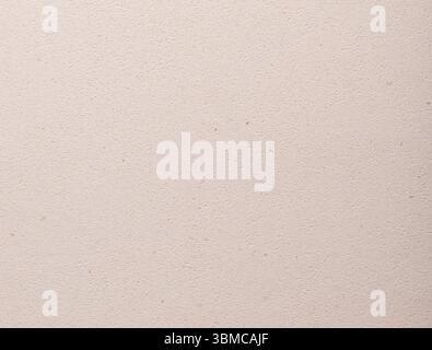 Flat sheet of designer paper in warm beige and cream tones with soft grainy texture and organic speckled surface. Natural recycled material in chic mi Stock Photo