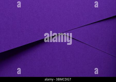 Premium designer paper in violet and purple tones with matte surface and elegant texture. Overlapping sheets create geometric shapes and simple lines Stock Photo