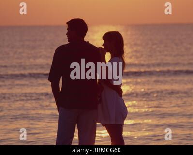 Thailand. Hua Hin. Young tourist couple on the beach at sunset. Stock Photo