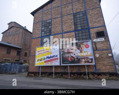 Large posters with advertising for billboards and fibre optics from Vodafone on the wall of an industrial building, Braunschweig, Lower Saxony, German Stock Photo