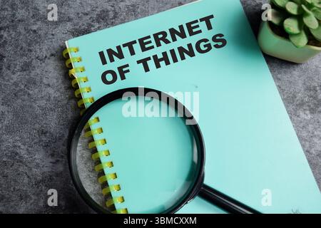 Concept of Internet of things write on book isolated on Wooden Table. Stock Photo