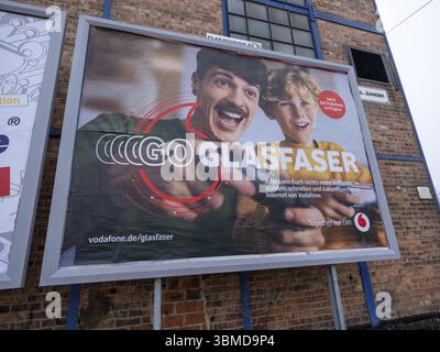 Advertising poster for fibre optics from Vodafone on the wall of an industrial building, Braunschweig, Lower Saxony, Germany, Europe Stock Photo