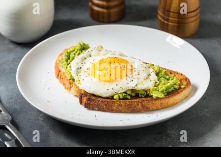 Healthy Homemade Avocado Toast with Over Easy Egg for Breakfast Stock Photo