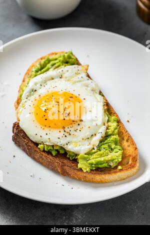 Healthy Homemade Avocado Toast with Over Easy Egg for Breakfast Stock Photo