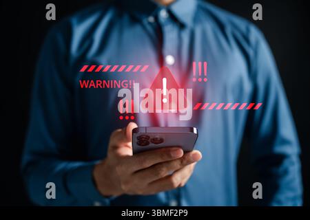 Cybersecurity warning alert on smartphone with red triangle Stock Photo