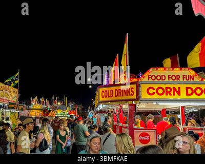 Sights and festive lights on the fairgrounds at night at the Calgary Stampede Stock Photo