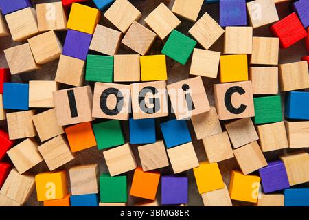 Many different colorful wooden cubes with word LOGIC on grey background, closeup Stock Photo