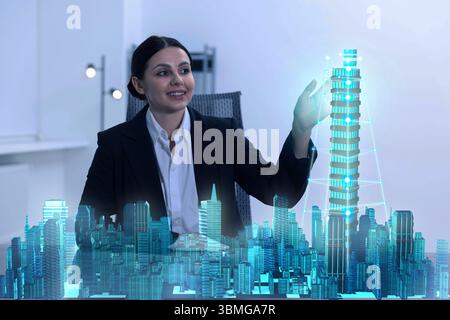 Building information modelling. Woman using holographic projection of city in office Stock Photo