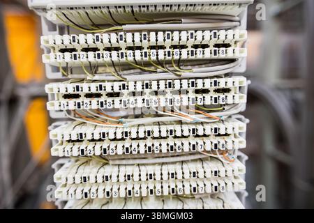 Flat design showing white terminal blocks with colored twisted-pair cables in rack, copy space Stock Photo
