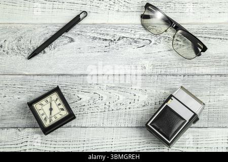 Morning. retro alarm clock, vintage electric shaver and sunglasses, optical glasses on shabby white wooden background Stock Photo