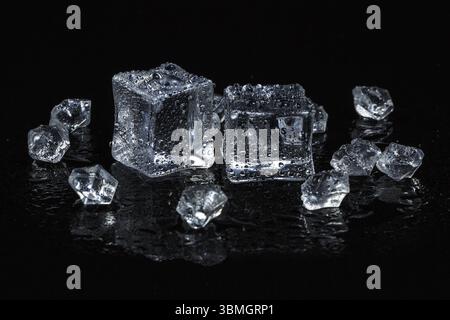 Ice cubes on black isolated glass background Stock Photo