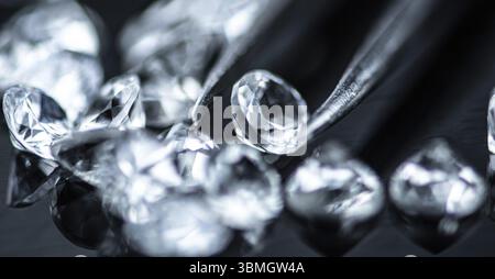 Small Diamonds on dark background as close up shot (selective focus) Stock Photo